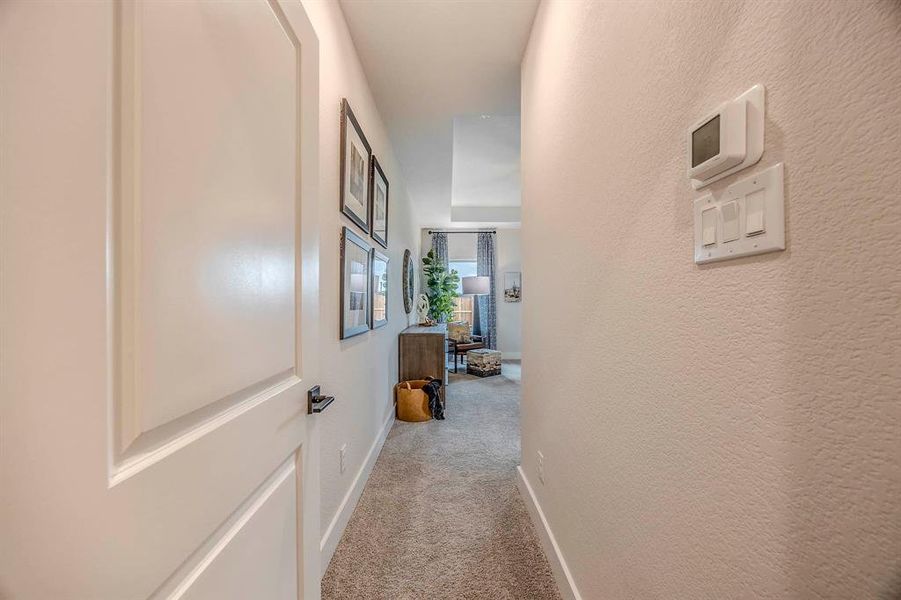 Hall featuring light colored carpet