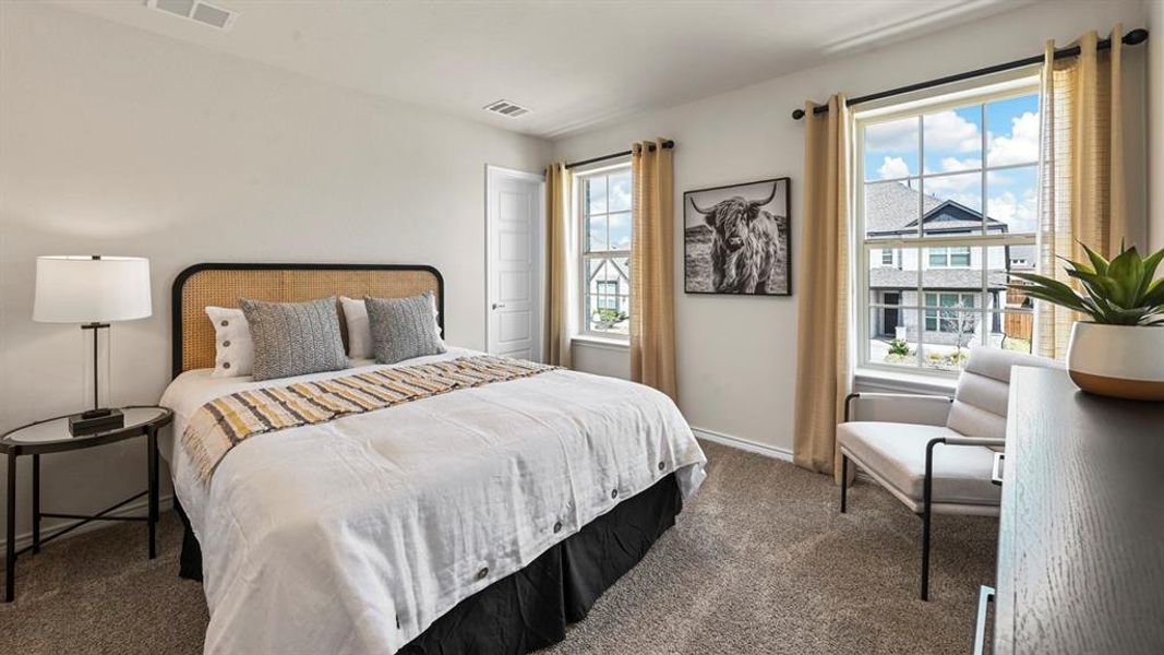Bedroom featuring dark carpet and baseboards Bedroom featuring dark carpet and baseboards