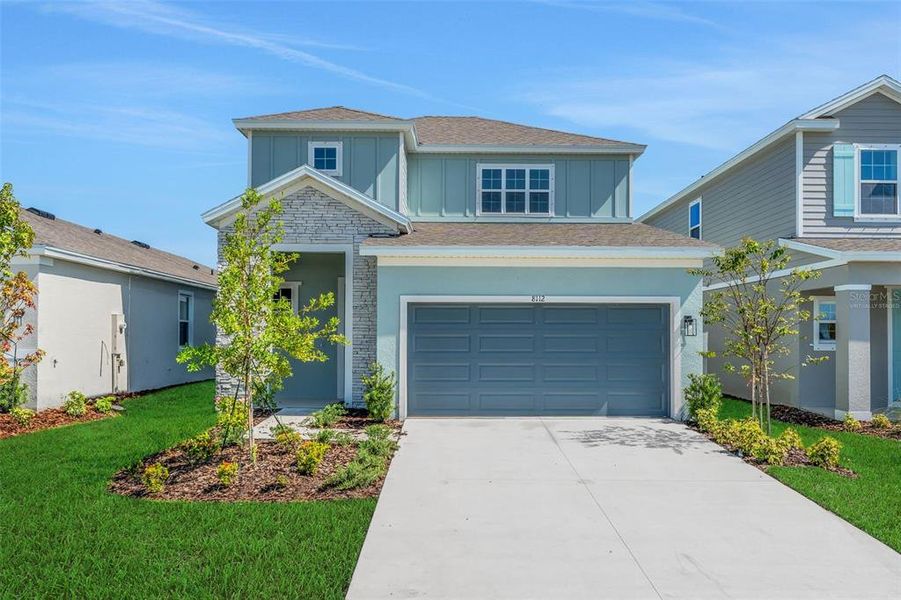 Front exterior of a new home in Seaire, Parrish, FL, highlighting curb appeal (Image 25).