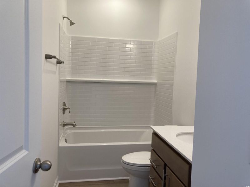 Bathroom with shower / bath combination and vanity