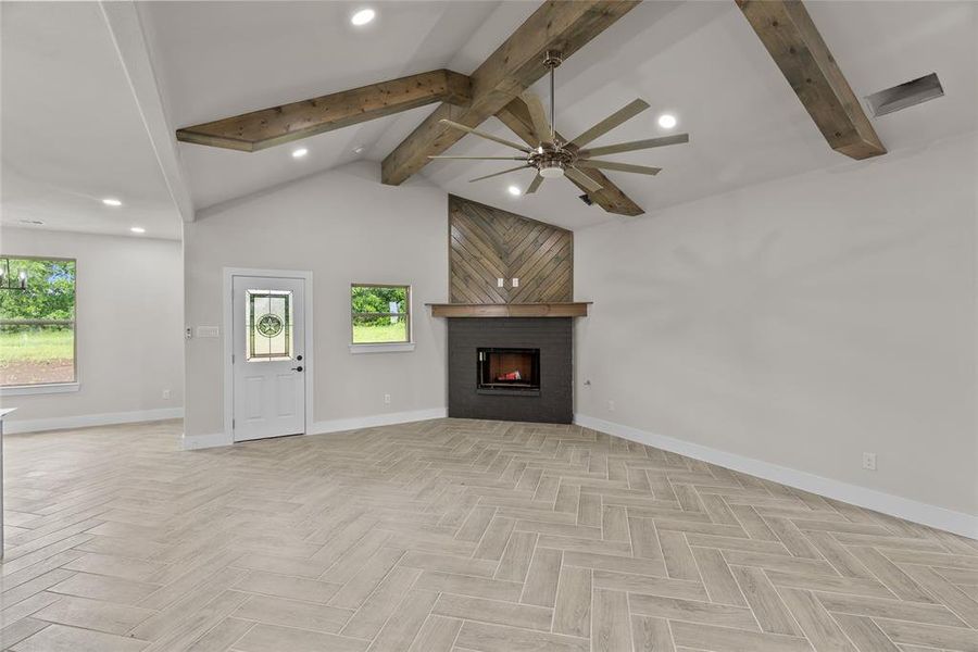 Unfurnished living room with ceiling fan, healthy amount of natural light, baseboards, a large fireplace, and recessed lighting