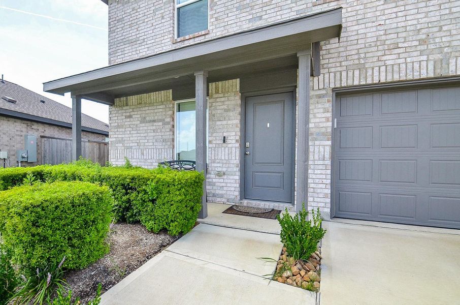 Bright and cozy living room with neutral walls and carpeting. It features a comfortable couch, decorative pillows, and a stylish coffee table. There's a window for natural light and a TV for entertainment, creating a welcoming space.
