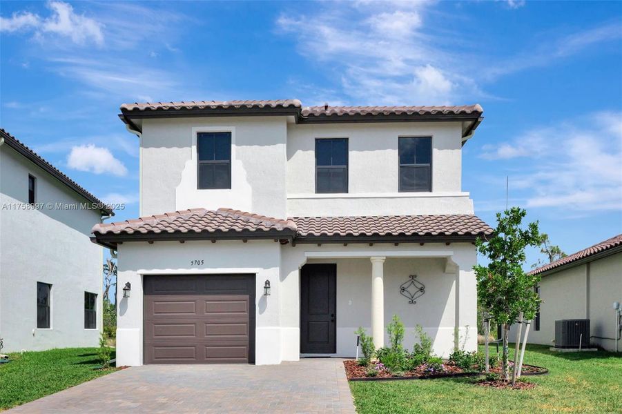 Front exterior of a new home in , Ave Maria, FL, highlighting curb appeal (Image 19).