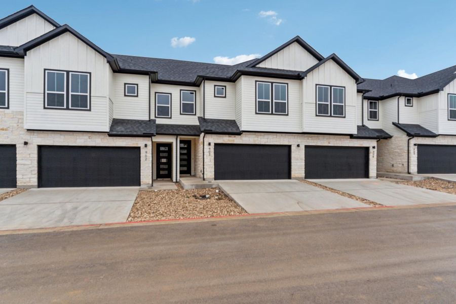 Front exterior of a new home in Townhomes at Gattis, Round Rock, TX, highlighting curb appeal (Image 1). Front exterior of a new home in Townhomes at Gattis, Round Rock, TX, highlighting curb appeal (Image 1).