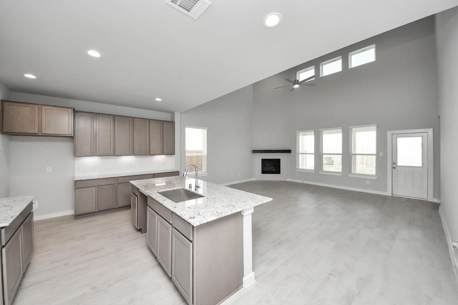 All of this overlooks your expansive family room, creating a perfect space for culinary delights and family gatherings. Sample photo of completed home with similar floor plan. Actual colors and selections may vary.