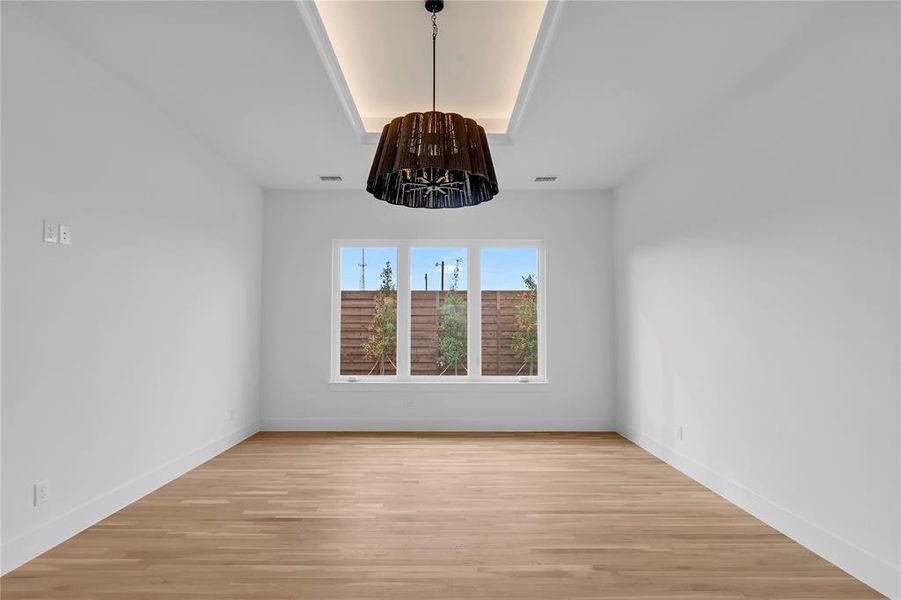 Unfurnished dining area featuring light wood finished floors and baseboards Unfurnished dining area featuring light wood finished floors and baseboards