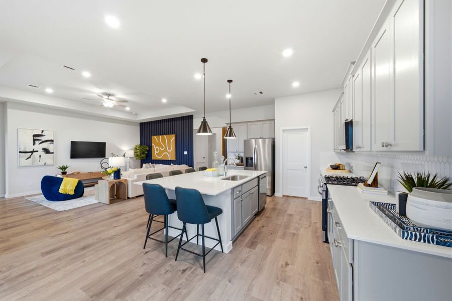 A kitchen with a bar and chairs. A kitchen with a bar and chairs.