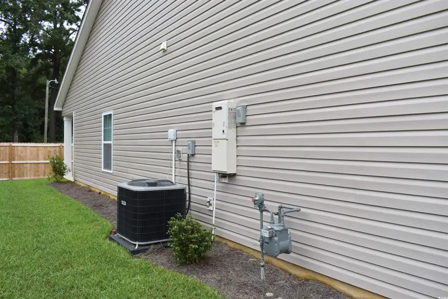 Exterior details and patio area of a home in Oak Hollow, Longs (Image 3).
