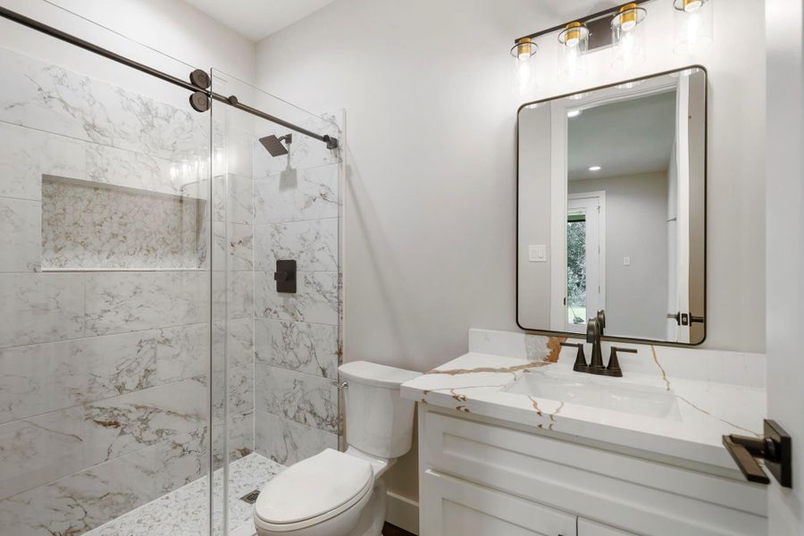 Another bathroom with a walk-in standing shower.