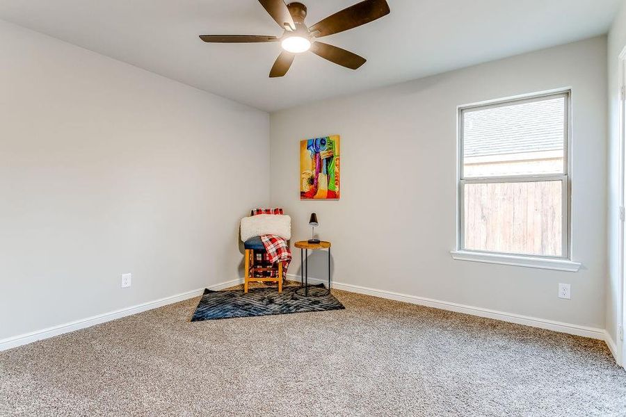 Sitting room featuring carpet and ceiling fan