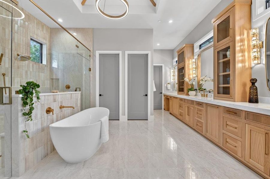 Freestanding soaking tub with gold-finish fixtures Freestanding soaking tub with gold-finish fixtures