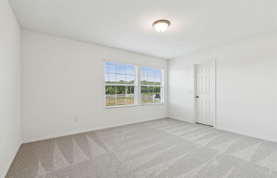 Secondary bedroom with ample closet space *real home pictured