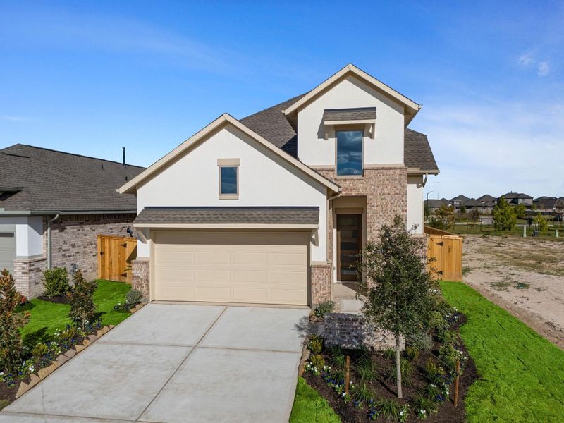 Front exterior of a new home in Bridgeland 40', Cypress, TX, highlighting curb appeal (Image 2). Front exterior of a new home in Bridgeland 40', Cypress, TX, highlighting curb appeal (Image 2).