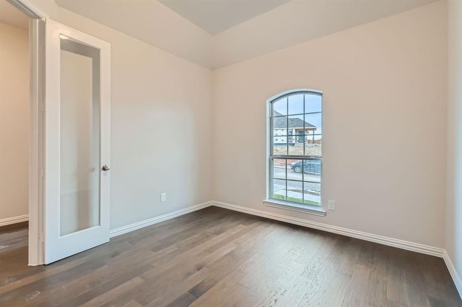 Spare room featuring dark hardwood / wood-style flooring