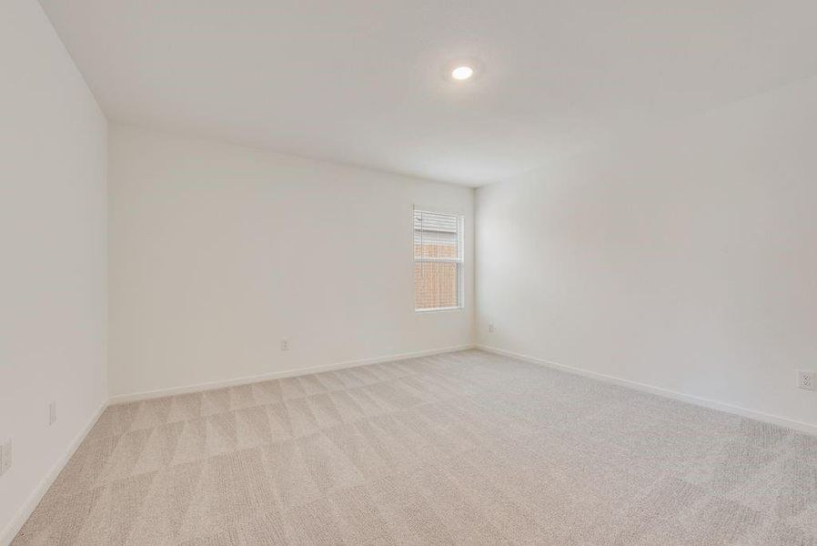 Empty room featuring light colored carpet