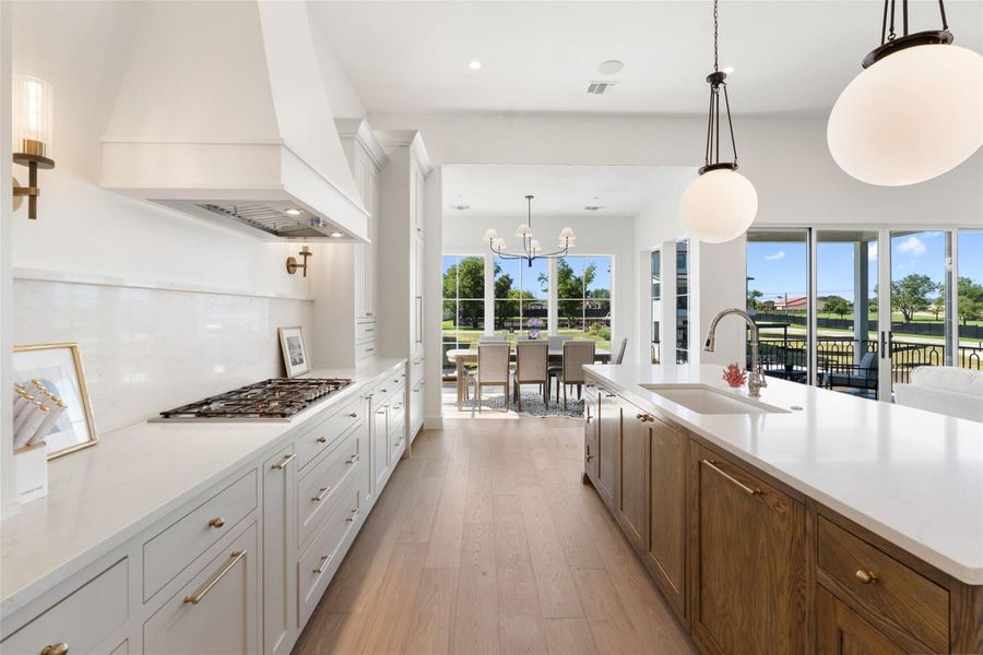Culinary excellence awaits in this open-concept kitchen, seamlessly connecting to an elegant dining area and a view of the outdoors. Culinary excellence awaits in this open-concept kitchen, seamlessly connecting to an elegant dining area and a view of the outdoors.
