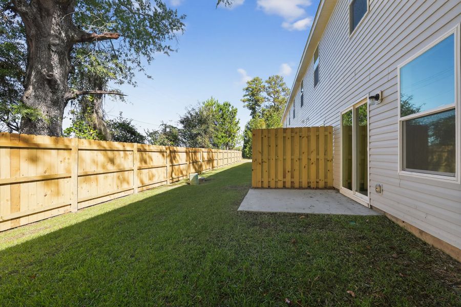 A fenced in yard next to a house.