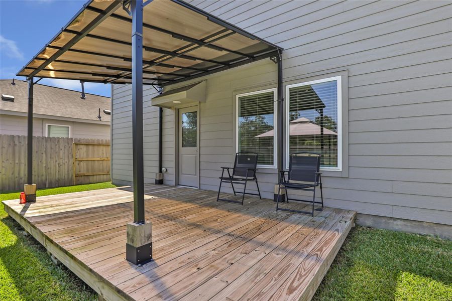 Covered deck -- a must in this Texas heat! So many possibilities in this back yard. Ample space for kids and fur babies.