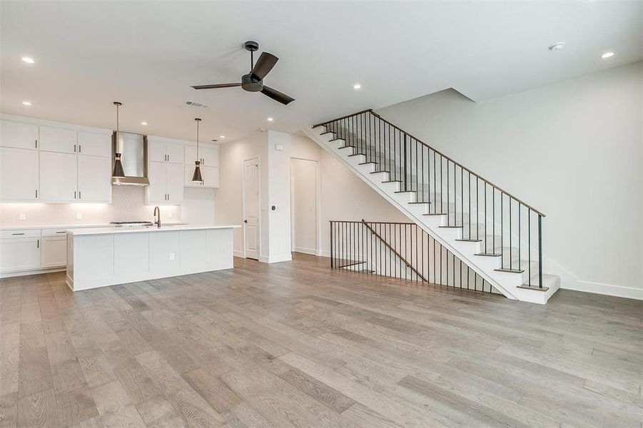 The open kitchen is bathed in natural light from large windows on both sides, creating a bright and welcoming atmosphere.