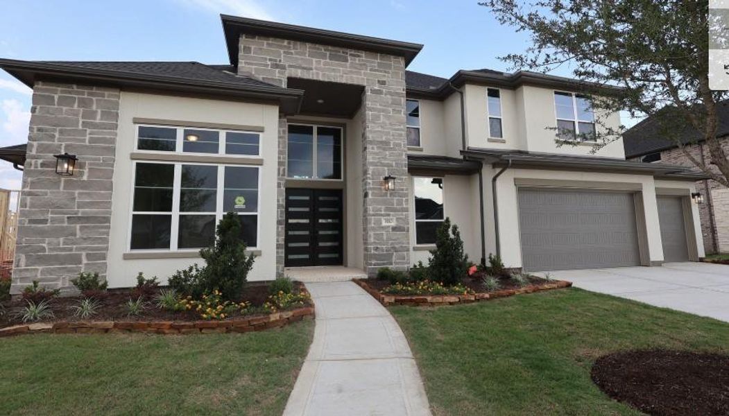 Front exterior of a new home in Harvest Green, Richmond, TX, highlighting curb appeal (Image 2). Front exterior of a new home in Harvest Green, Richmond, TX, highlighting curb appeal (Image 2).