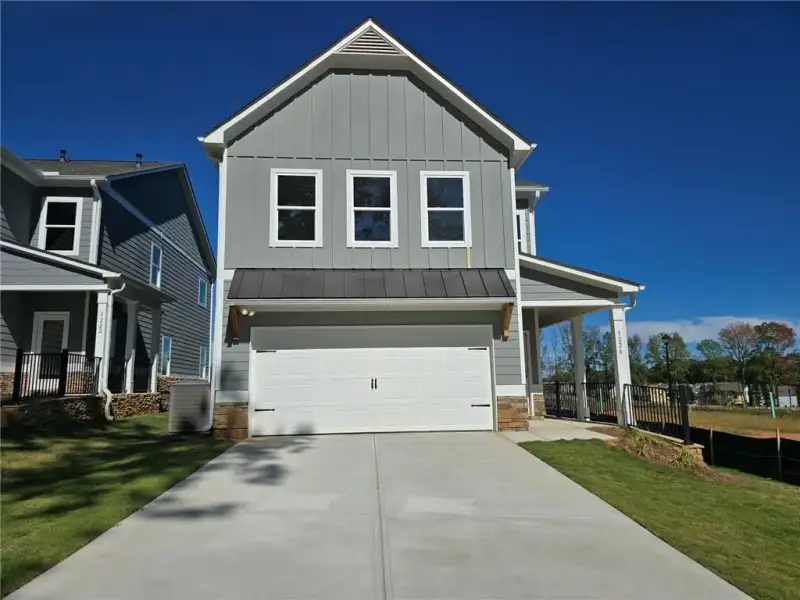 Front exterior of a new home in Magnolia Trace, Flowery Branch, GA, highlighting curb appeal (Image 2). Front exterior of a new home in Magnolia Trace, Flowery Branch, GA, highlighting curb appeal (Image 2).