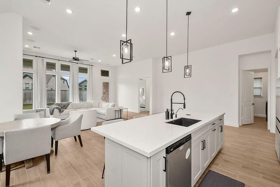 Open concept living, dining room, and kitchen. The large windows flood this home with tons of natural light Open concept living, dining room, and kitchen. The large windows flood this home with tons of natural light