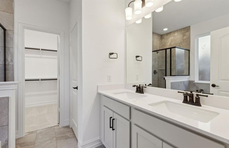 Spacious owner's bathroom with dual vanity *real home pictured