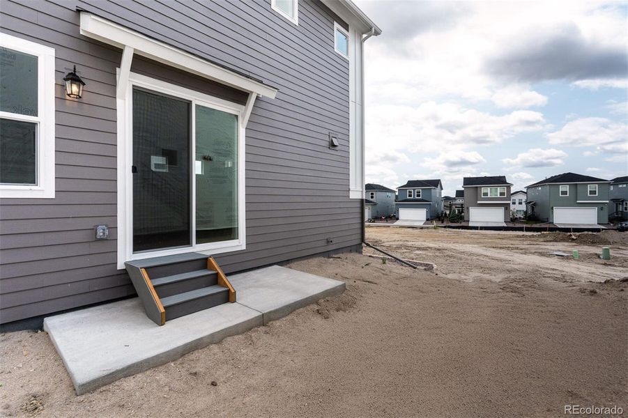 Front exterior of a new home in Revel Crossing at Wolf Ranch – The Ascent Collection, Colorado Springs, CO, highlighting curb appeal (Image 2).