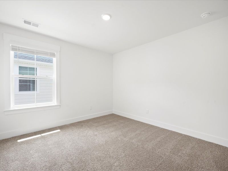 Spacious, unfurnished interior of a new home in The Coves at Lakes of Cane Bay, Summerville (Image 35).