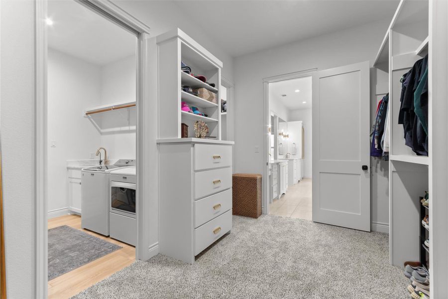 AMAZING PRIMARY CLOSET with two rooms and built in shelves and drawer OPEN TO LAUNDRY room with sink and storage. AMAZING PRIMARY CLOSET with two rooms and built in shelves and drawer OPEN TO LAUNDRY room with sink and storage.