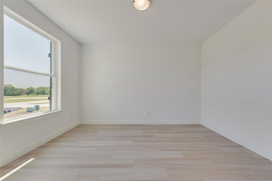 Spare room featuring light wood-type flooring