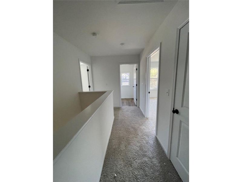 This spacious hallway offers a bright and inviting