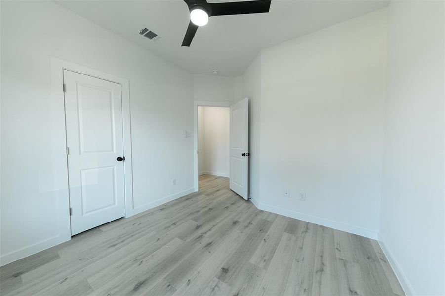 Unfurnished bedroom featuring light wood-type flooring and ceiling fan