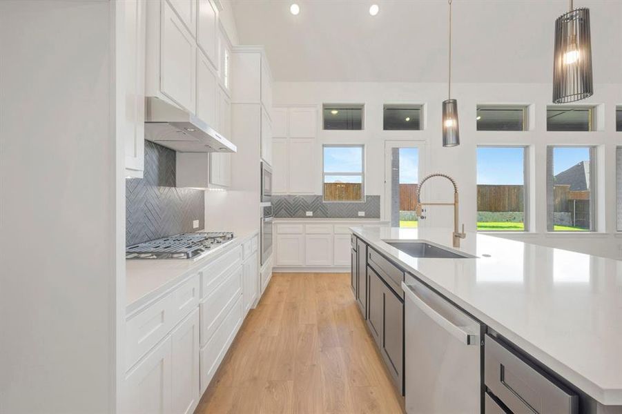 Expansive kitchen island featuring a deep undermount sink and contemporary faucet Expansive kitchen island featuring a deep undermount sink and contemporary faucet