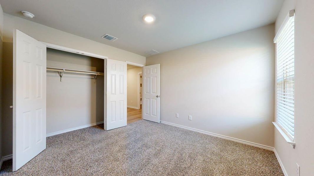 Unfurnished bedroom featuring carpet floors and a closet