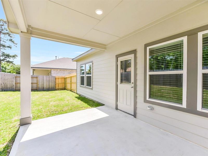 Exterior details and patio area of a home in Windmill Estates, Magnolia (Image 4).