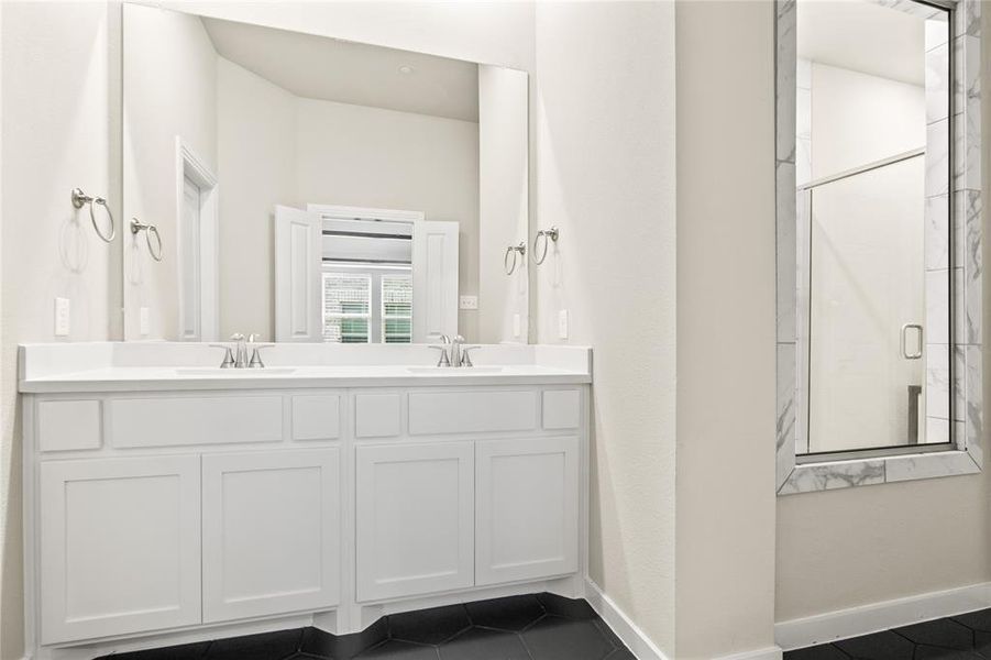 Bathroom with tile floors and double sink vanity