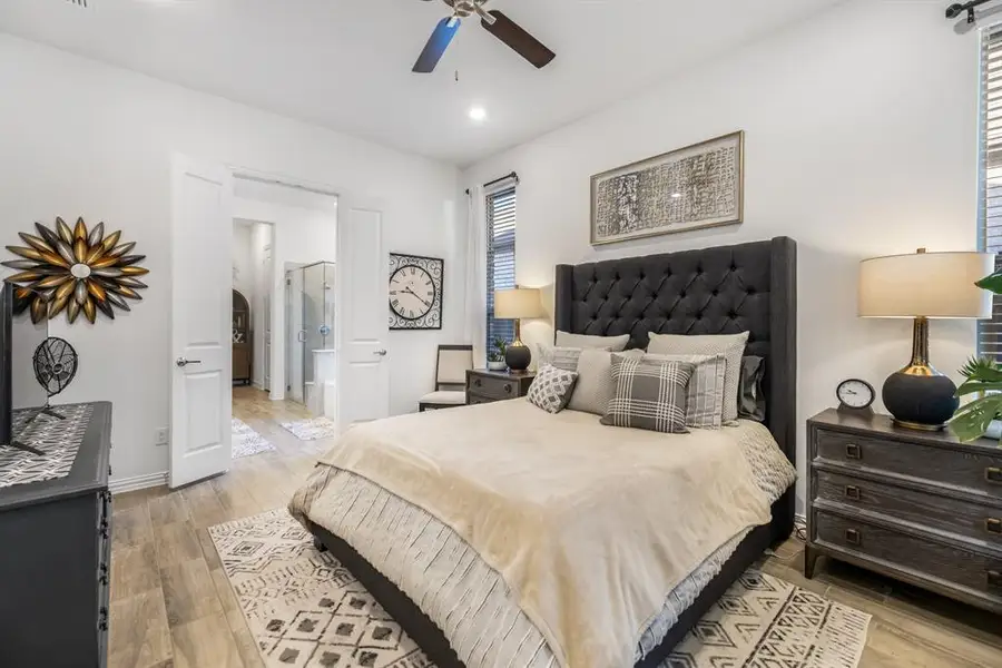Bedroom featuring light wood-style floors, connected bathroom, a ceiling fan, and recessed lighting Bedroom featuring light wood-style floors, connected bathroom, a ceiling fan, and recessed lighting