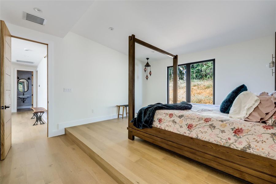 Bedroom featuring light wood-style flooring and baseboards