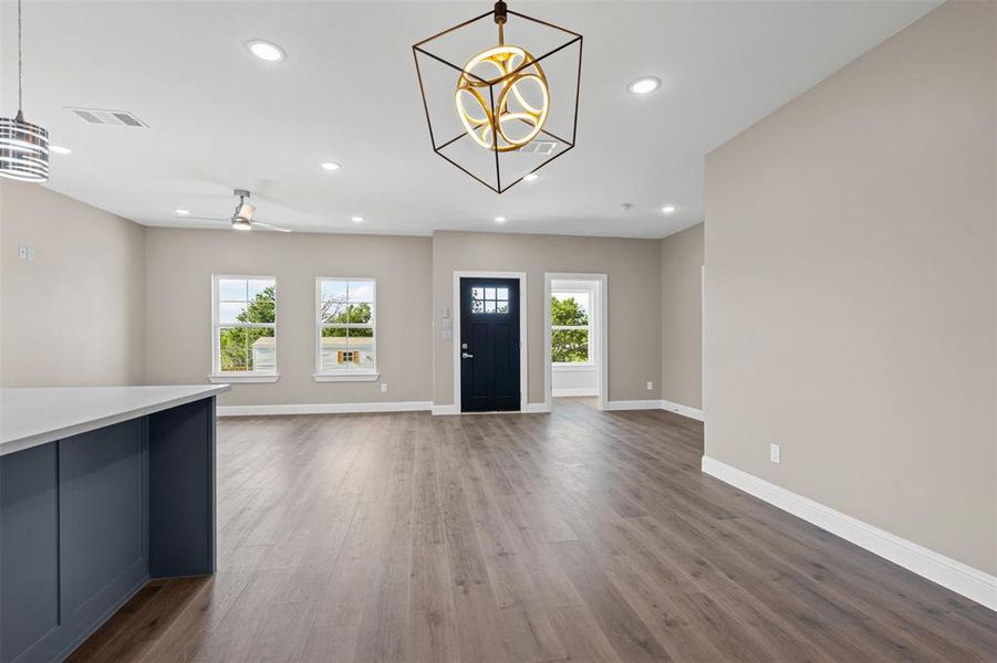 Foyer entrance featuring a chandelier, dark wood-type flooring, recessed lighting, and ceiling fan Foyer entrance featuring a chandelier, dark wood-type flooring, recessed lighting, and ceiling fan