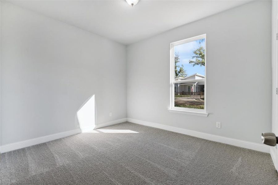 Empty room featuring plenty of natural light and carpet floors