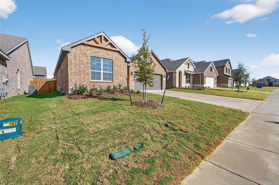 Front exterior of a new home in Liberty Pointe, Gainesville, TX, highlighting curb appeal (Image 1). Front exterior of a new home in Liberty Pointe, Gainesville, TX, highlighting curb appeal (Image 1).