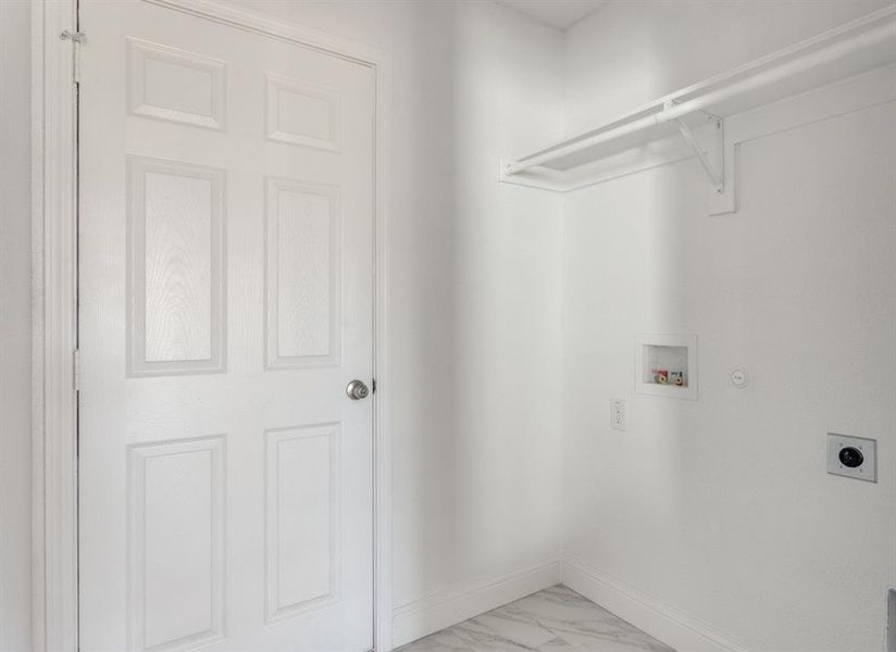 Washroom with washer hookup, light marble finish flooring, hookup for a gas dryer, and hookup for an electric dryer