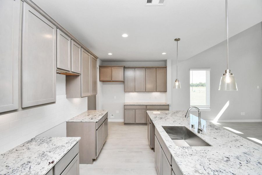 This kitchen is by far any chef’s dream! This spacious kitchen features high ceilings, stained wood cabinets, granite countertop, SS appliances, modern tile backsplash, recessed lighting, extended counter space, granite kitchen island with double sink, and space for breakfast bar, and a walk-in pantry all overlooking your huge family room. Sample photo of completed home with similar floor plan. Actual colors and selections may vary. This kitchen is by far any chef’s dream! This spacious kitchen features high ceilings, stained wood cabinets, granite countertop, SS appliances, modern tile backsplash, recessed lighting, extended counter space, granite kitchen island with double sink, and space for breakfast bar, and a walk-in pantry all overlooking your huge family room. Sample photo of completed home with similar floor plan. Actual colors and selections may vary.