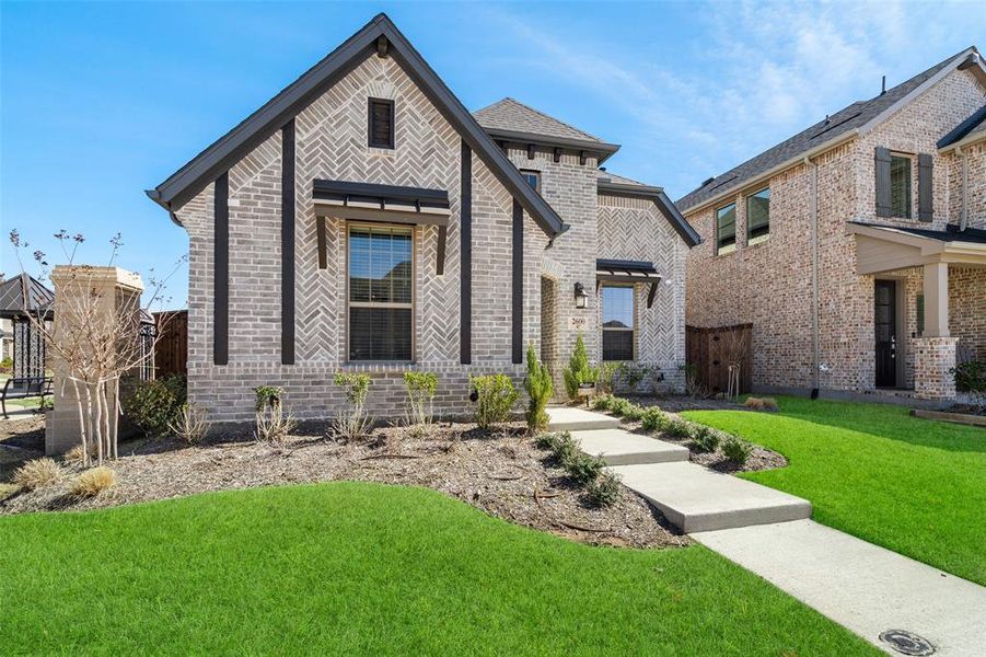 Front exterior of a new home in Cambridge Crossing, Celina, TX, highlighting curb appeal (Image 24).