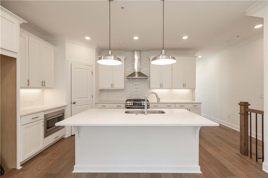 The corner walk in pantry has plenty of space for all your kitchen staples. Add some stools at the island for a casual dining spot.