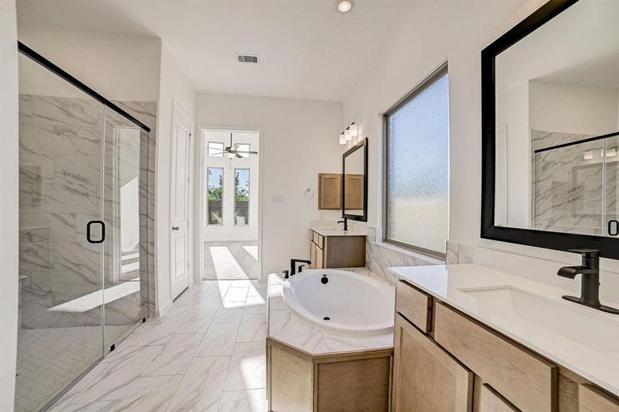 Opposite view of primary bath leading into the primary bedroom.