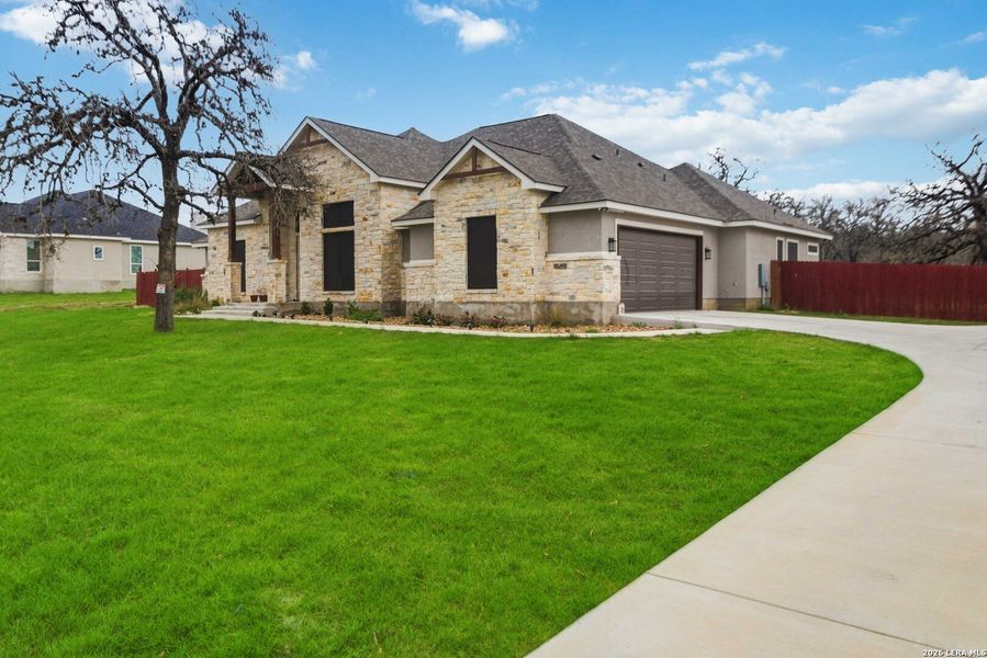 Front exterior of a new home in , La Vernia, TX, highlighting curb appeal (Image 25).