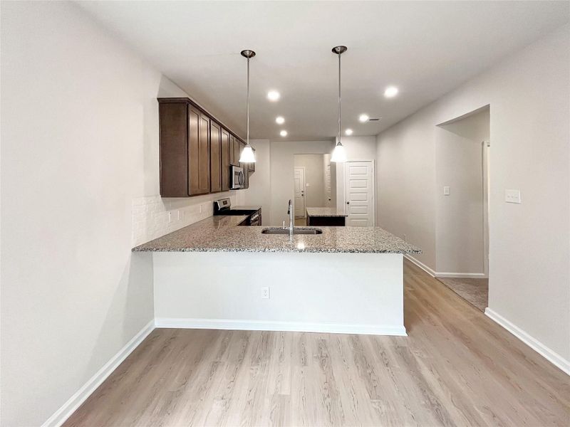 The Cardinal II- Breakfast Area into Kitchen. Home under construction. Sample floor plan photo used for illustrative purposes only. Upgrades, selections options, windows and colors may vary.