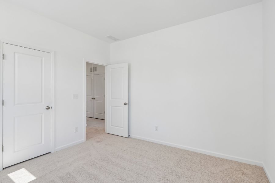 Spacious, unfurnished interior of a new home in Terraces at the Exchange, Indian Land (Image 31).